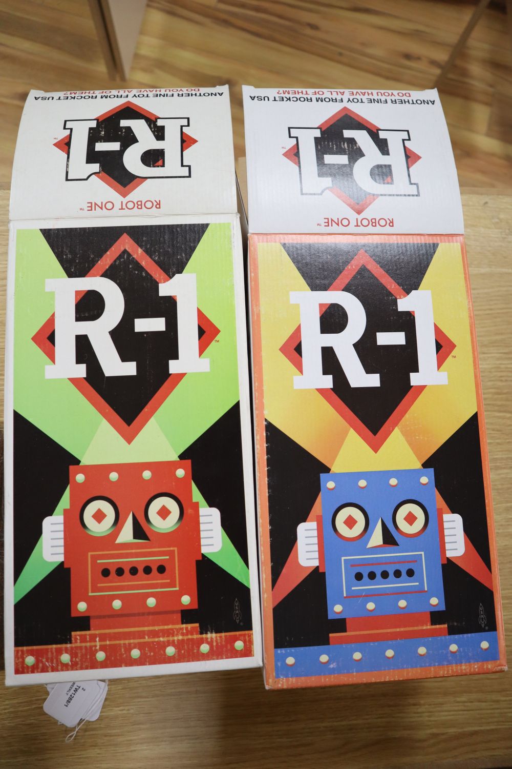 Rocket USA, a rare limited edition 2001 Red R-1 Robot with Black Band, No. 15/34 and a blue version of the R-1 Robot,